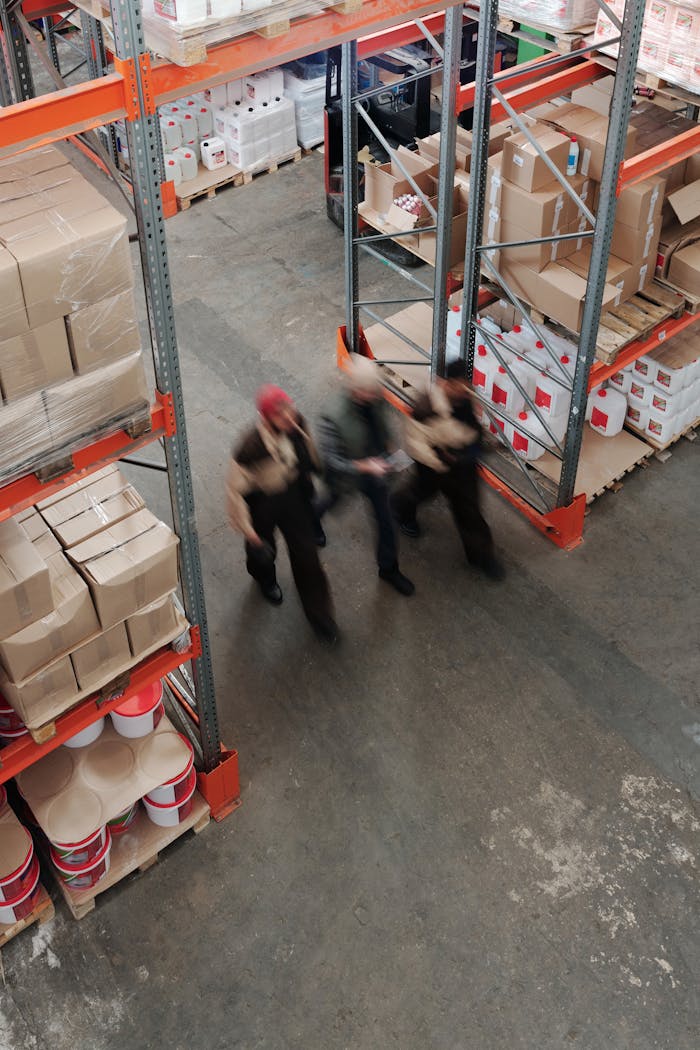 our-story Blurred motion of workers managing inventory in a warehouse.
